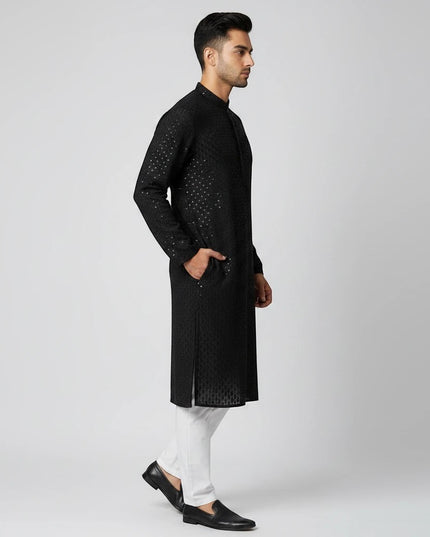 Man wearing a Kurti Connection USA black embroidered traditional kurta with a mandarin collar and side pockets