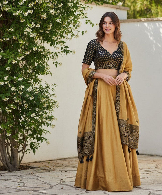 Kurti Connection USA black and gold brocade blouse with floral embroidery and sweetheart neckline, paired with a mustard lehenga.