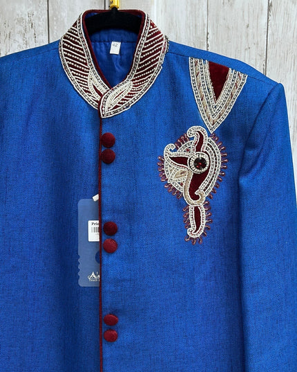 Kurti Connection USA blue sherwani jacket with intricate embroidery, mandarin collar, and red velvet button accents.