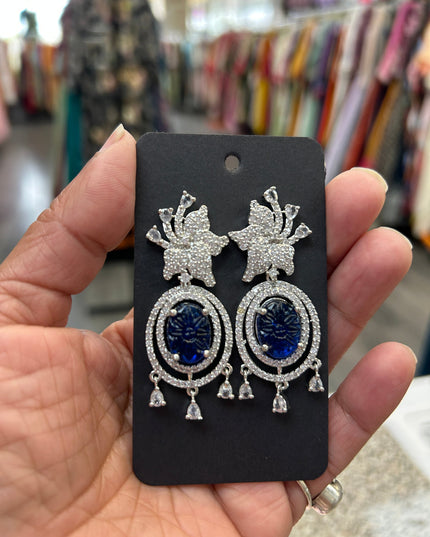 Kurti Connection USA oval blue gemstone dangle earrings with cubic zirconia halo and floral top.