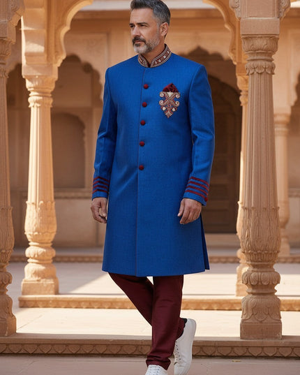 Kurti Connection USA blue sherwani jacket with red velvet accents, mandarin collar, and embroidery, worn by a man.