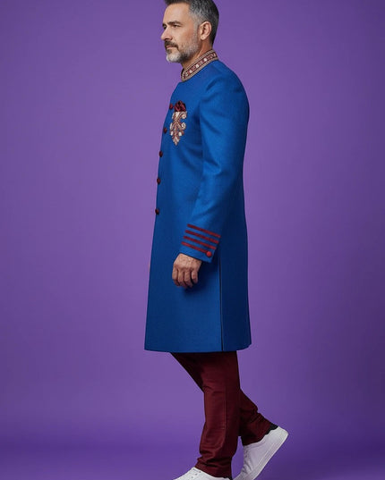 Kurti Connection USA blue sherwani jacket with red velvet accents, mandarin collar, and embroidery on purple background