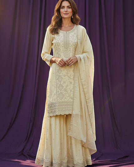 Kurti Connection USA cream silk blend kurti sharara set with silver embroidery and sequin dupatta.