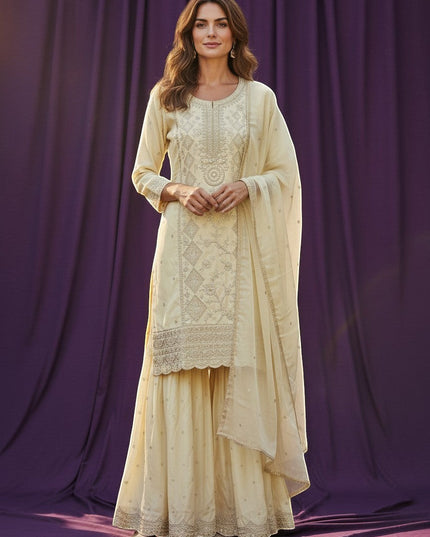 Kurti Connection USA cream silk blend kurti sharara set with silver embroidery and sequin dupatta.
