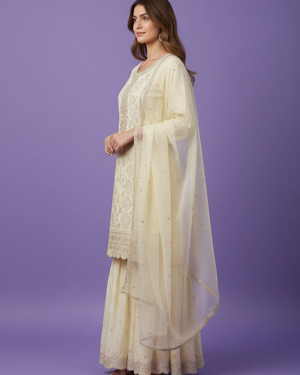 Kurti Connection USA cream silk blend kurti sharara set with silver embroidery and sequin dupatta.