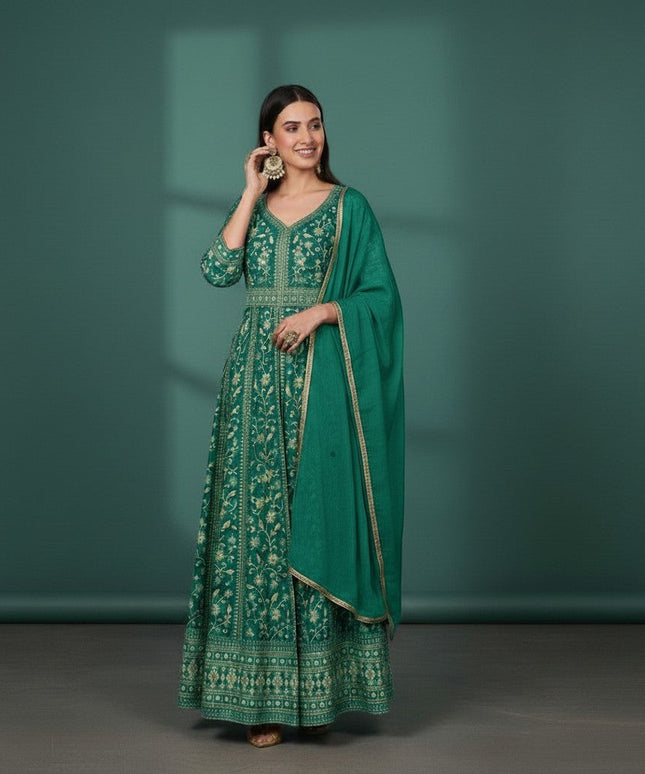 Kurti Connection USA emerald green Anarkali suit with gold embroidery and dupatta. Model wears large gold earrings.