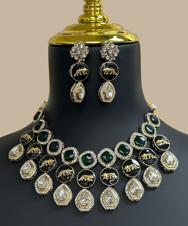 Kurti Connection USA multi-layered necklace and earring set with emerald green stones, black animal motifs, and gold.