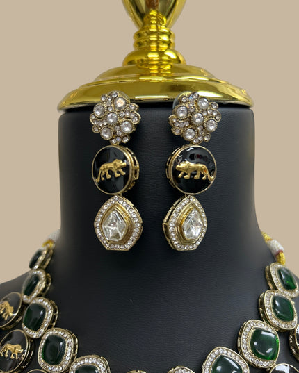 Kurti Connection USA ethnic jewelry set with emerald green stones, black animal motifs, and sparkling white crystals.