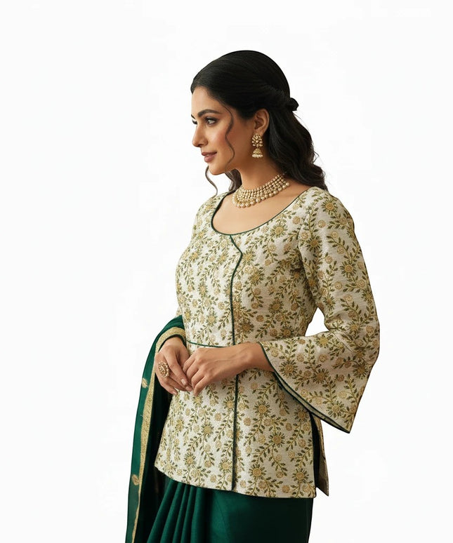 Kurti Connection USA long blouse in cream with floral embroidery, bell sleeves, and green trim worn with a lehenga