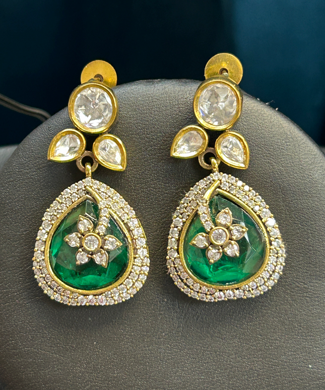 Kurti Connection USA elegant teardrop earrings featuring deep green stones, floral motifs, and white crystal halos.