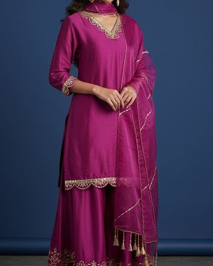Kurti Connection USA magenta silk sharara suit with gold embroidery on neckline, cuffs, and hem. Includes matching dupatta.