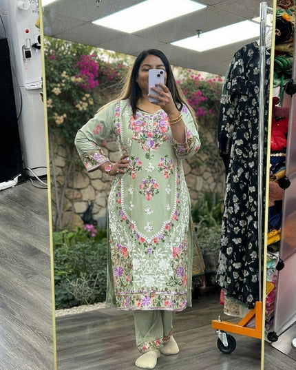 Kurti Connection USA sage green kurti set with multi-colored floral embroidery, round neck, and matching trousers.