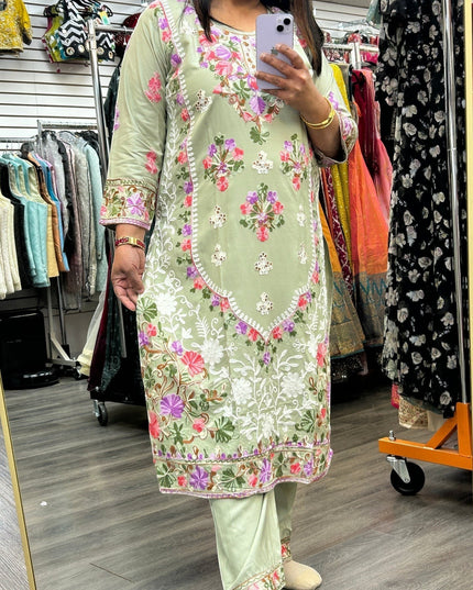 Kurti Connection USA sage green kurti set with intricate multi-colored floral embroidery and three-quarter sleeves.