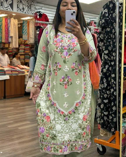Kurti Connection USA sage green kurti set with intricate multi-colored floral embroidery and three-quarter sleeves.