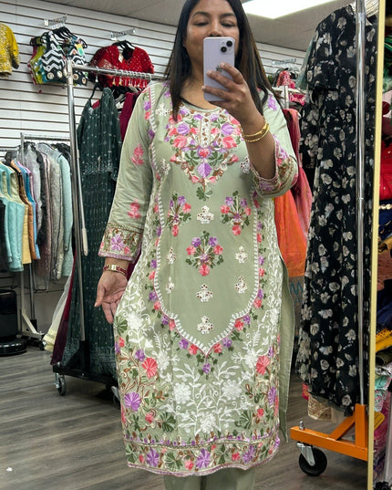 Kurti Connection USA sage green kurti set featuring intricate multi-colored floral embroidery on the front and sleeves.