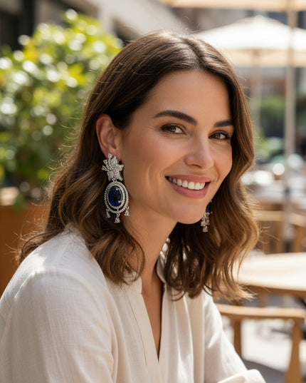 Kurti Connection USA ornate silver drop earrings with blue carved stones and clear cubic zirconia accents.
