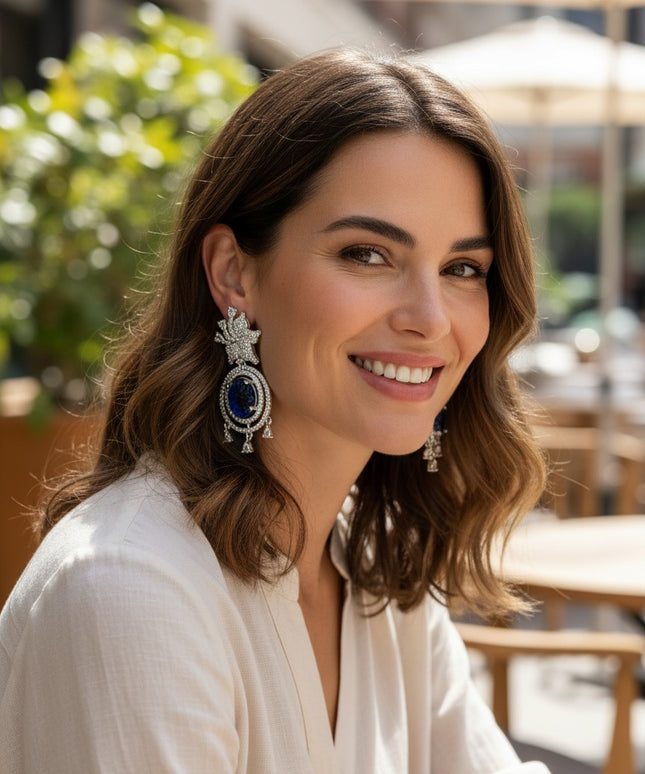 Kurti Connection USA ornate silver drop earrings with blue carved stones and clear cubic zirconia accents.