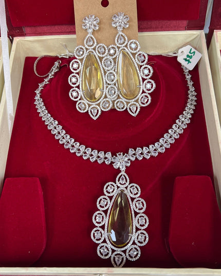 Kurti Connection USA statement necklace set with teardrop yellow stones and clear crystals, matching dangle earrings.