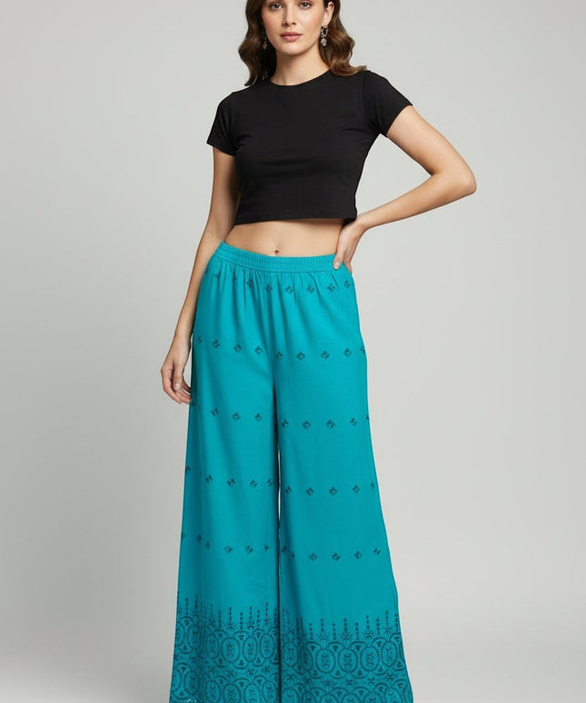 Model wearing Kurti Connection USA teal wide-leg palazzo trousers with intricate embroidery and a scalloped hem