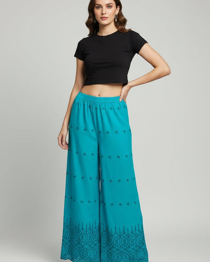 Kurti Connection USA teal wide-leg palazzo trousers with intricate embroidery and scalloped hem on a model
