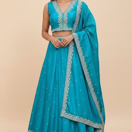 Model wearing a turquoise Kurti Connection USA lehenga choli set with silver embroidery and matching dupatta