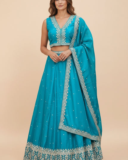 Model wearing a turquoise Kurti Connection USA lehenga choli set with silver embroidery and matching dupatta