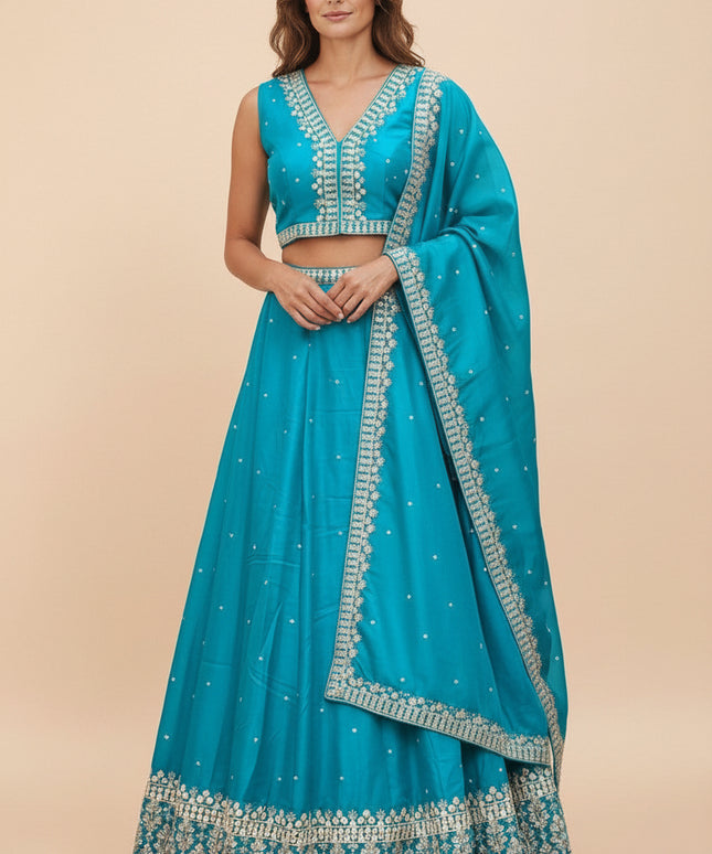 Model wearing a turquoise Kurti Connection USA lehenga choli set with silver embroidery and matching dupatta