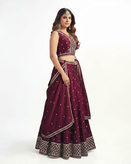 Kurti Connection USA wine sleeveless lehenga choli with silver embroidery, flared skirt, and matching dupatta.