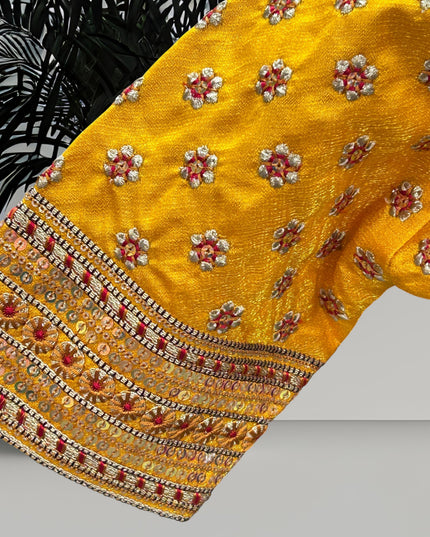Kurti Connection USA yellow blouse sleeve with intricate floral embroidery, metallic thread work, and sequin borders.