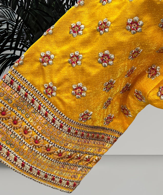 Kurti Connection USA yellow blouse sleeve with intricate floral embroidery, metallic thread work, and sequin borders.