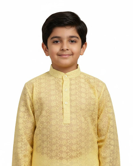 Young boy wearing a Kurti Connection USA yellow embroidered kurta with a mandarin collar on a white background